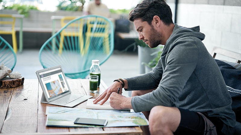 Man sitting at table with tablet 