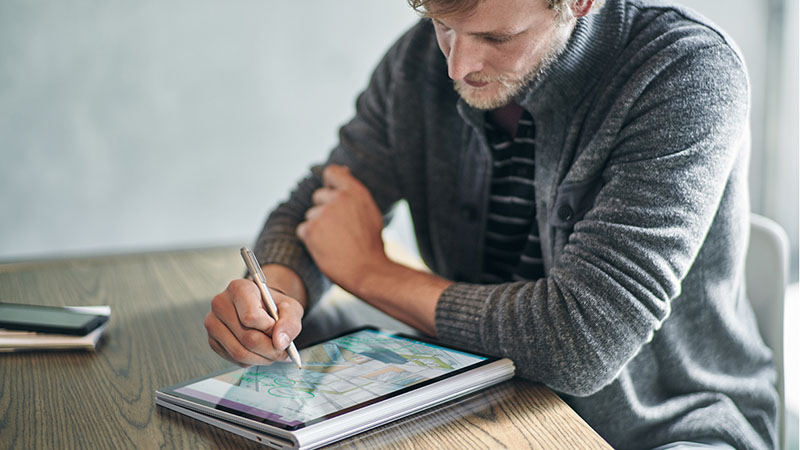 Man writing on tablet with pen